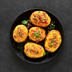 Baked stuffed potatoes with bacon, green onion and cheddar cheese