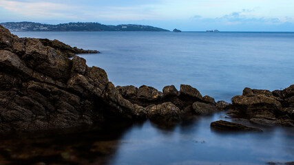 Rocky cove at the blue hour. smooth water after long exposure at this coastline.