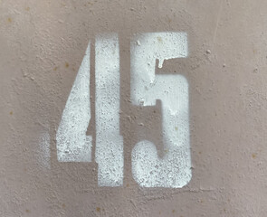 White number 45 on textured background with old paint