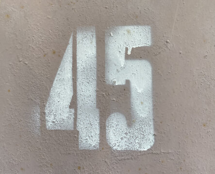 White number 45 on textured background with old paint