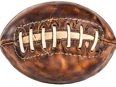 Vintage Leather Football on Green Pitch with Scoreboard in Background
