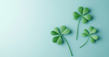 Three cute, cartoon-style shamrock leaves sit on a light blue background, in a playful, flat-lay arrangement. Bright colors and soft lighting create a cheerful design, ideal for seasonal celebrations.