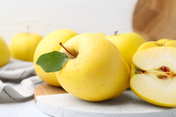 Fresh ripe yellow apples on white table, closeup