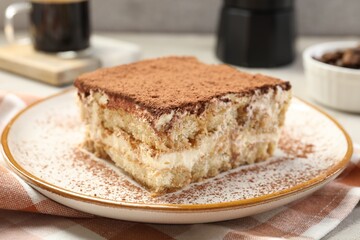 Piece of tasty tiramisu on table, closeup