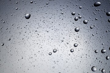 Water drops on grey glass surface, top view