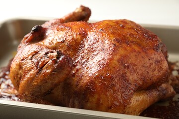 Delicious baked turkey in baking dish on light table, closeup