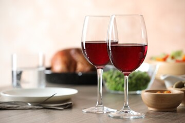 Red wine and delicious dinner served on wooden table