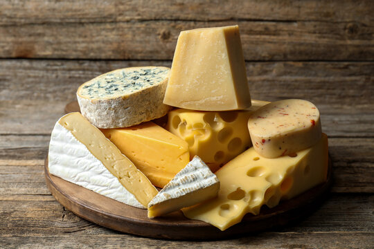 Different types of cheese on wooden table