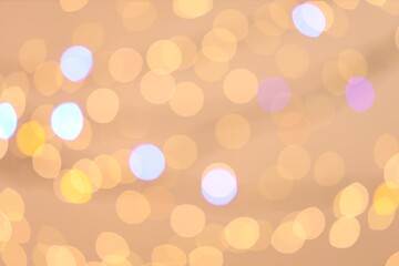 Blurred view of colorful lights on light background, bokeh effect