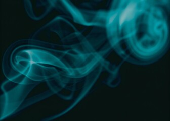 Obraz premium Abstract blue swirling smoke vapor against on dark background