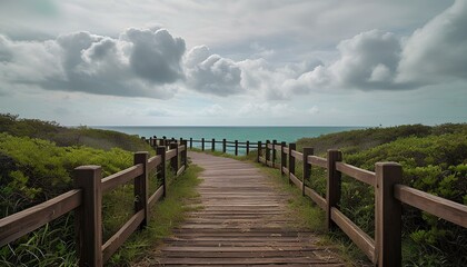 Obraz premium Wooden Dock Path Leading Out Towards the Beach with Calm Waters and Serene Horizon