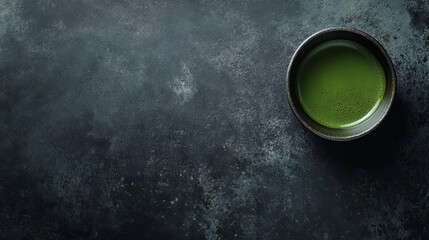 Matcha Green Tea in a Dark Ceramic Cup on a Dark Stone Surface