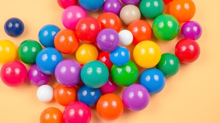 Fototapeta premium Colorful plastic balls scattered on a pastel background.
