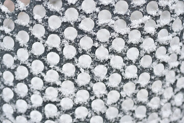 A Close-Up of Frost Patterns on a Textured Surface, Highlighting the Intricate Details and Natural Beauty of Winter.