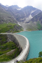 Kaprun high mountain reservoirs, Stausee Mooserboden coastline and Mooserbodenstrasse - cloudy summer day, August 20, 2024. Mountains, glacier, water reservoir - nice view before the storm from top.