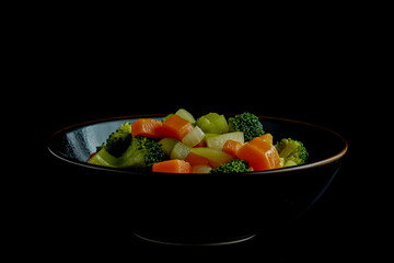 Steamed Vegetable Salad in a Bowl on Black Background