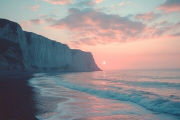 Obraz premium Cliffside beach during pastel-colored sunset
