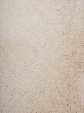 A neutral beige surface displays soft variations in tone and texture, ideal for backgrounds in design projects or as a modern tabletop. Its simplicity enhances versatility in creative endeavors