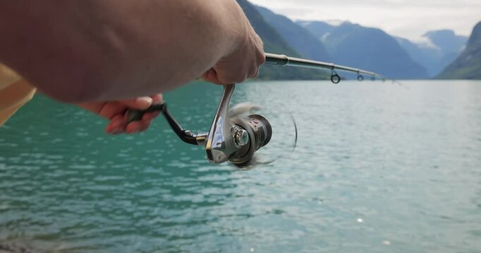 Woman fishing on Fishing rod spinning in Norway.