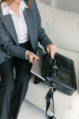 A woman puts a laptop in a case, close-up