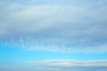 Blue sky with cloudy haze. Celestial atmospheric background.