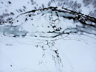 Aerial view at 90° angle of a frozen lake with ice floes