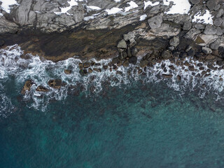 Coast, waves and Norwegian sea, aerial shots at 90° angle