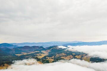 Viewers are captivated by the stunning vista of hills and valleys softly covered in a blanket of clouds