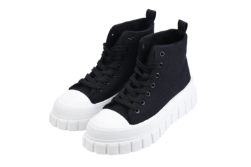 A pair of black sneakers with white soles isolated on a white background.