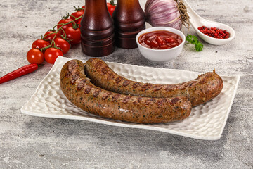 Grilled beef sausages with sauce
