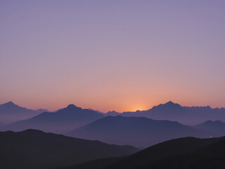 Obraz premium a serene and minimalistic sunset over a silhouette of distant mountains.