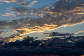 Red sunset over the sea, rich in dark clouds, rays of light. Black Sea coast, early autumn