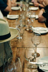 tableware Glasses, flower fork, knife served for dinner in restaurant with cozy interior