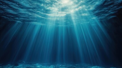 Sunlight beams down through deep blue ocean water. Sunlight rays illuminate dark depths. Tranquil underwater scene. Calm ocean surface. Beautiful underwater landscape. Aquatic nature scene. Peaceful,