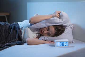 Asian women opened eyes lying on the bed have an insomnia problems.