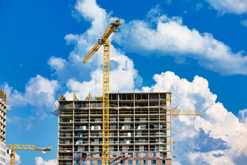 Construction cranes working on a tall building © Dmitry Naumov