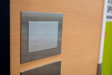 Elevator entrance braille system in a shopping mall