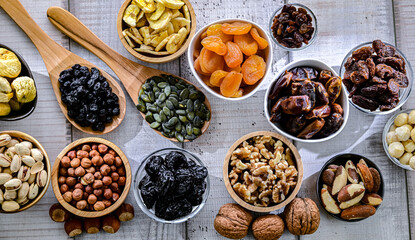 Composition with a variety of dried fruits and assorted nuts.