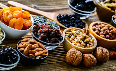 Composition with a variety of dried fruits and assorted nuts.