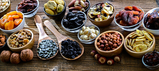 Composition with a variety of dried fruits and assorted nuts.