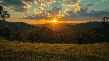 Majestic golden sunset over rolling hills casting a warm glow on lush landscapes and grassy fields