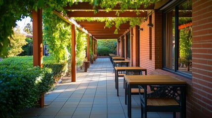 Obraz premium A serene outdoor dining area with tables shaded by lush greenery.