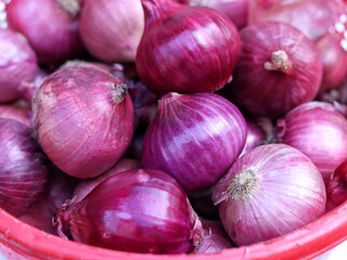Close up view od red onions on market stall