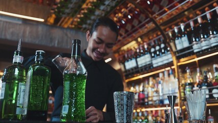 Asian bartender pouring mixed cocktail juice liqueur all ingredient into sliver shaker alcohol drink, making special advertisement creative tasty, focused refreshing showcase at bar luxury. Vinosity.