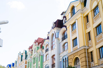Multicolor modern exterior of houses buildings. Windows facade. Bright architecture street. Sky copy space