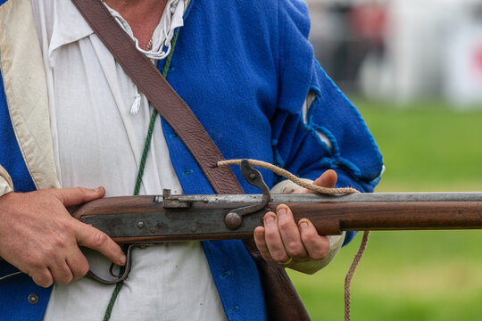 Holding a matchlock musket