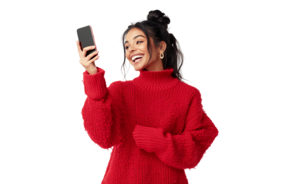 Happy woman in a red sweater holding a smartphone horizontally, pointing at it cheerfully with a bright expression, set against a clean white background.

