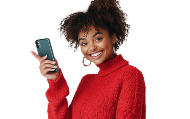 Happy woman in a red sweater holding a smartphone horizontally, pointing at it cheerfully with a bright expression, set against a clean white background.