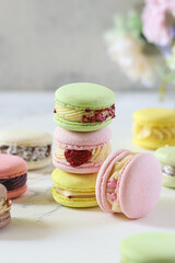 Colorful macarons stacked on a table showcasing various flavors and pastel hues in an elegant setting