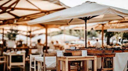 Fototapeta premium Outdoor market scene with fruit baskets, tables, chairs, and parasols.